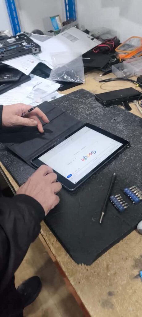 Technician repairing iPhone battery replacement service